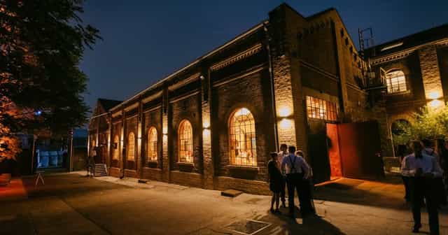 Industrial outdoor reception at Harbour.Club with atmospheric perimeter uplighting.