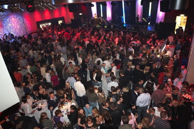 Corporate networking event at Club Bohème with LED lighting and crowded dance floor.