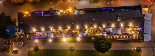 Rheinloft Cologne rooftop lounge with purple ambient lighting for networking and cocktail events.