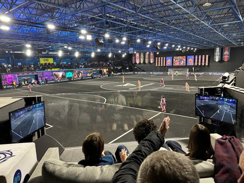 Soundstage sports arena with stadium seating for immersive event and AV production.