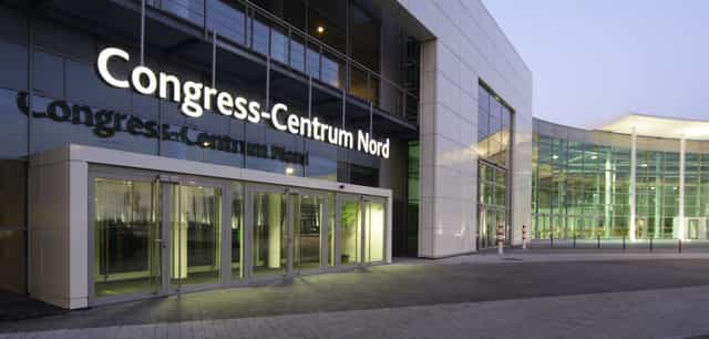 Gürzenich Köln convention center entrance with glass facade for corporate events and conferences.