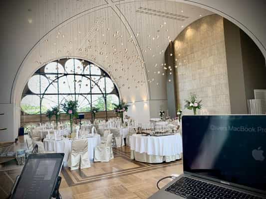 Elegant Dachsalon event space in Flora Köln with table settings for corporate gala or conference.