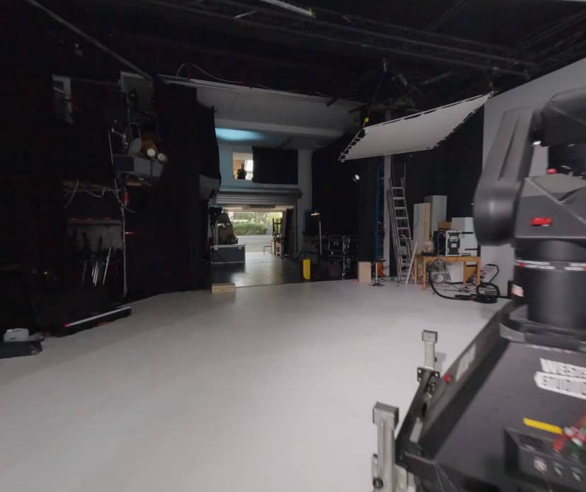Versatile Westside Studios event space with sleek white flooring and advanced AV setup.
