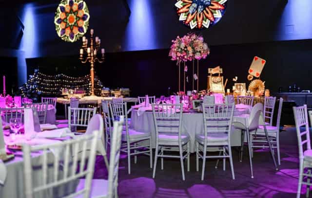 Alice in Wonderland themed gala at Carlswerk Victoria featuring elegant purple lighting.
