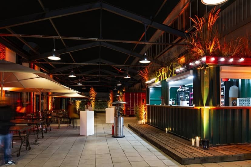Club Volta industrial outdoor event space with container bar for evening receptions.