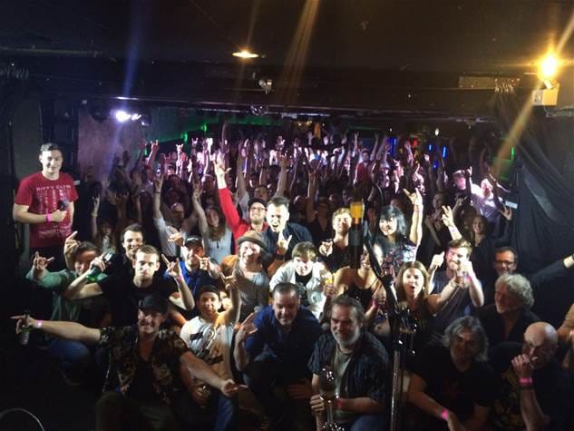 Packed Luxor function room for live event with high-energy audience and capacity crowds.