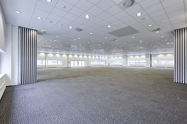 Ballroom at XPOST Conference Center with floor-to-ceiling windows for gala and exhibition events.
