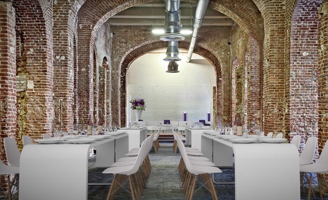Industrial-chic event hall with brick vaulted ceilings for corporate and wedding venue rental.