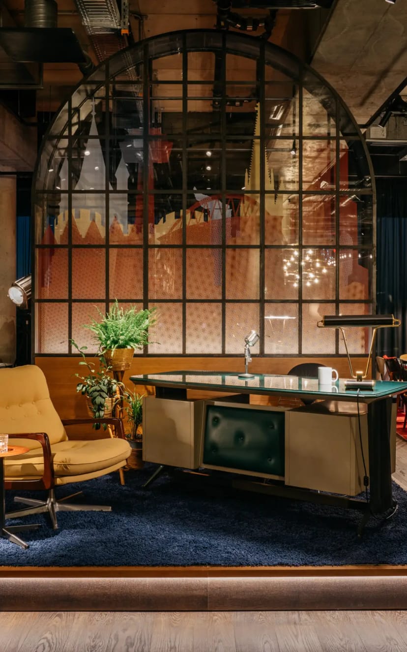 Fireside chat studio at Hotel Ruby Ella with professional desk and lighting for podcast interviews.