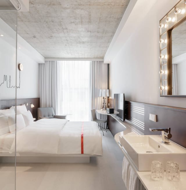 Modern Ruby Ella hotel room with minimalist decor for corporate events and conference lodging.