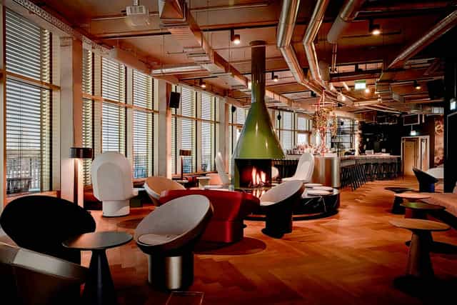 Industrial-chic networking reception venue with statement fireplace at 25hours Hotel The Circle.