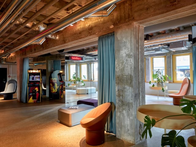 Industrial-chic breakout area with lounge seating for networking and corporate brainstorming events.