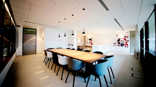 Lukas Podolski Box at RheinEnergieSTADION: Modern boardroom space for workshops and meetings.