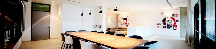 Lukas Podolski Box at RheinEnergieSTADION: modern boardroom and lounge for corporate event spaces.