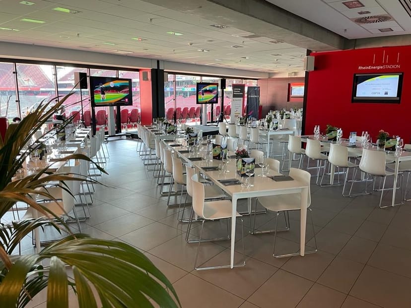 Dombar hospitality suite at RheinEnergieSTADION with pitch views for corporate events and banquets.