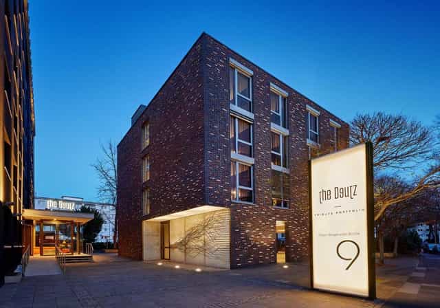 Boutique Deutz hotel venue exterior for executive retreats and modern board meetings.