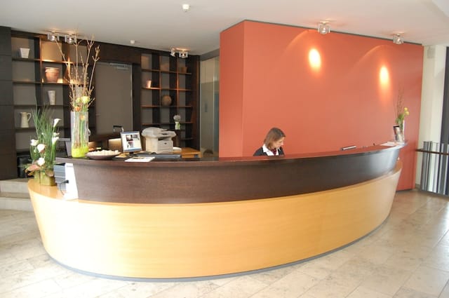 Hotel Begardenhof reception desk for event check-in and conference registration.