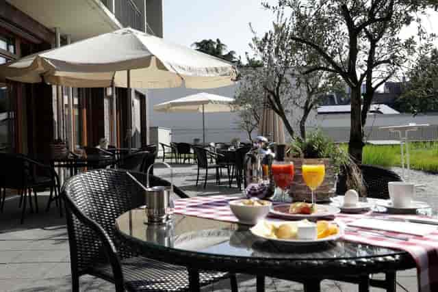 Al fresco hotel terrace set for networking breakfast and corporate event breakout.