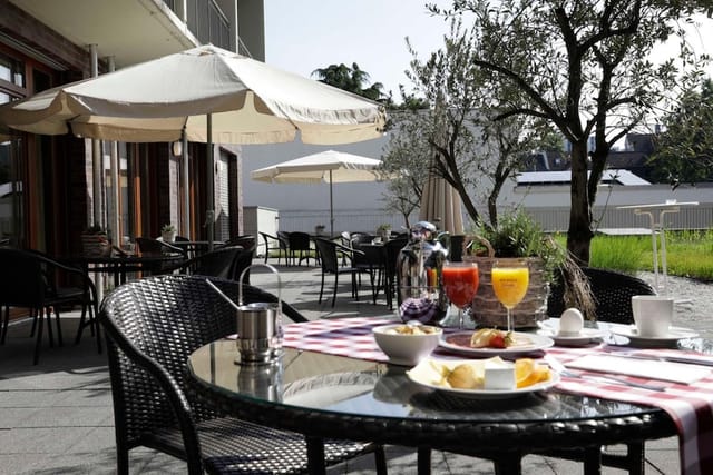 Al fresco hotel terrace set for networking breakfast and corporate event breakout.