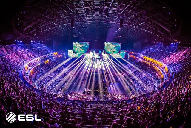 360-degree esports arena stage with immersive LED screens and lighting at LANXESS event.