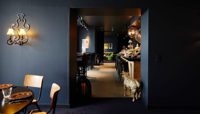 Chic dark restaurant interior for intimate evening receptions and networking events.