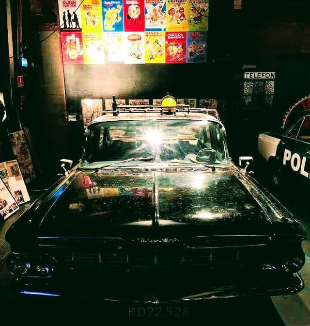 Vintage taxi prop in Nordisk Film event space for immersive themed corporate parties.