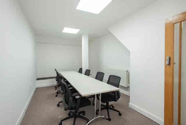 Minimalist meeting room with ergonomic chairs at Hub 56 for collaborative events.