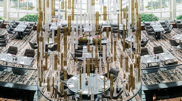Upscale Glashaus Restaurant dining room with sculptural installation for gala event venue.