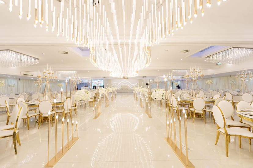 Luxury ballroom with dramatic lighting for opulent wedding or gala dinner event venue.