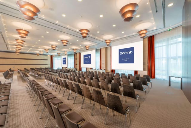 Radisson Blu theater-style conference room with dual screens for corporate events and presentations.