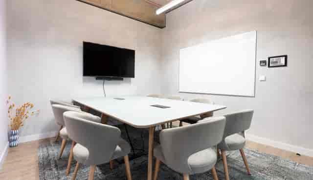 Modern meeting room with sleek table and chairs, ideal for collaboration events.