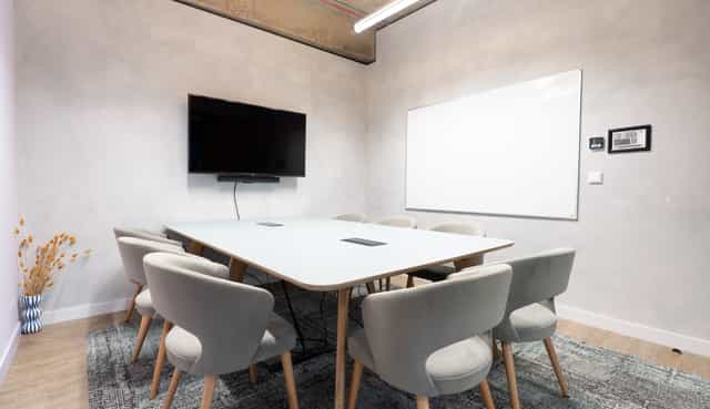 Modern meeting room with sleek table and chairs, ideal for collaboration events.