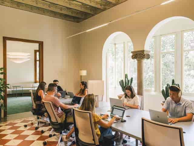 Modern flexible workspace at Casa Les Punxes with ergonomic seating for coworking and office design.