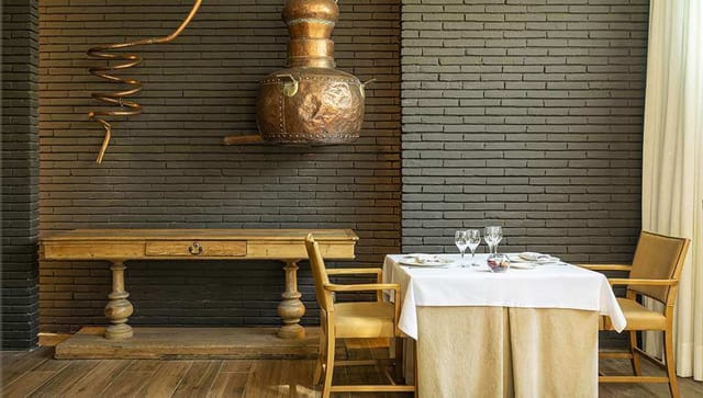 Private dining room with textured brick wall, perfect for corporate dinners and VIP events.
