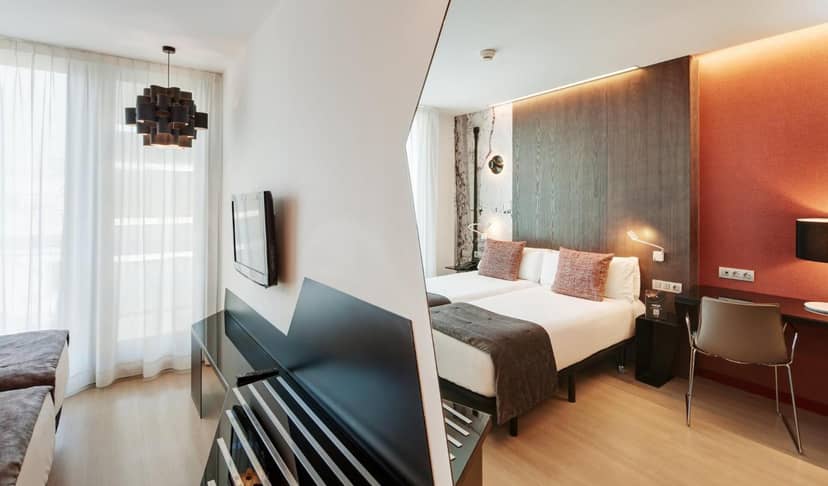 Modern hotel room with dual beds and workspace for business travel and corporate events.