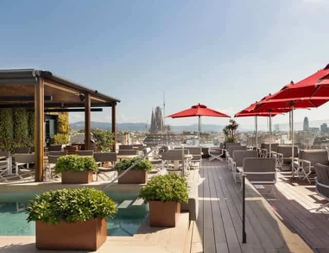 Rooftop cocktail bar with Sagrada Familia view for upscale networking events.