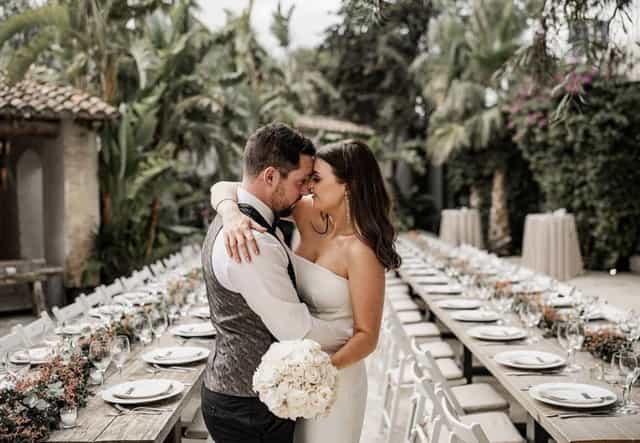 Al fresco wedding at Masia Victoria, featuring a long-table garden setup for elegant ceremonies.