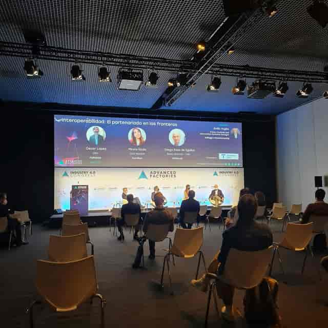 B2B panel discussion at CCIB Barcelona, stage with LED backdrop and socially-distanced seating.