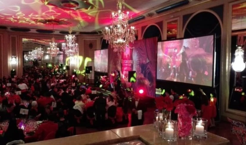 Corporate gala at Salón Imperial Barcelona with dramatic lighting and branded stage.