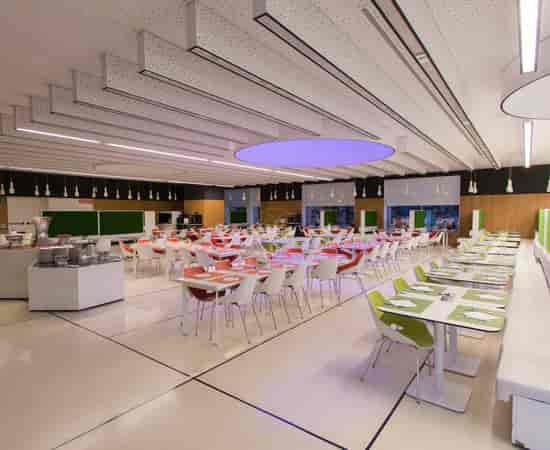 Modern corporate event space with modular tables, ideal for networking and business catering.