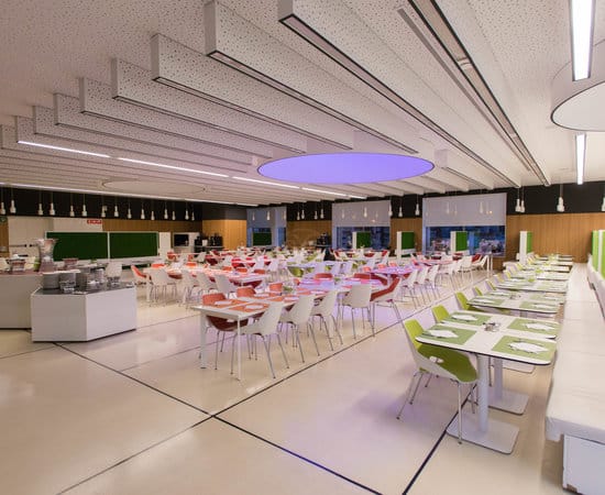 Modern corporate event space with modular tables, ideal for networking and business catering.