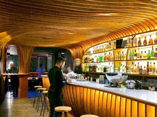 Sophisticated Noble Barcelona cocktail bar with architectural millwork for VIP reception events.