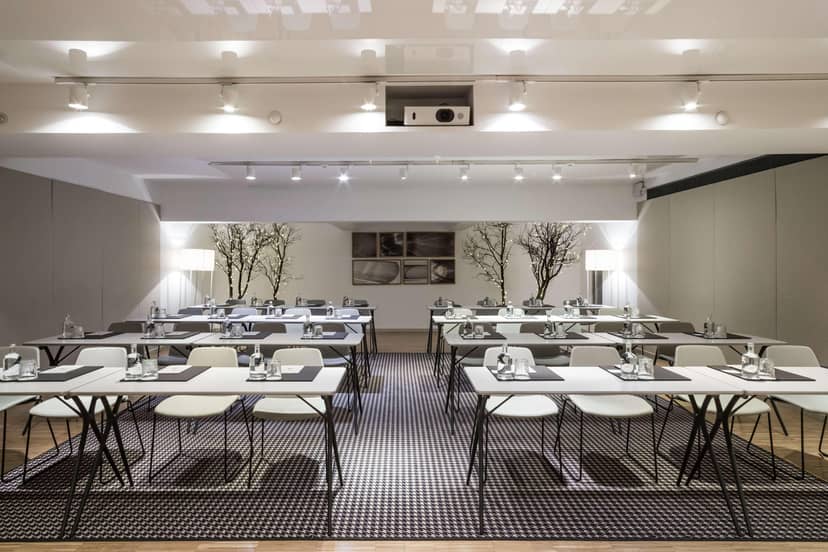 Modern classroom-style meeting room at Alexandra Barcelona Hotel for corporate workshops.