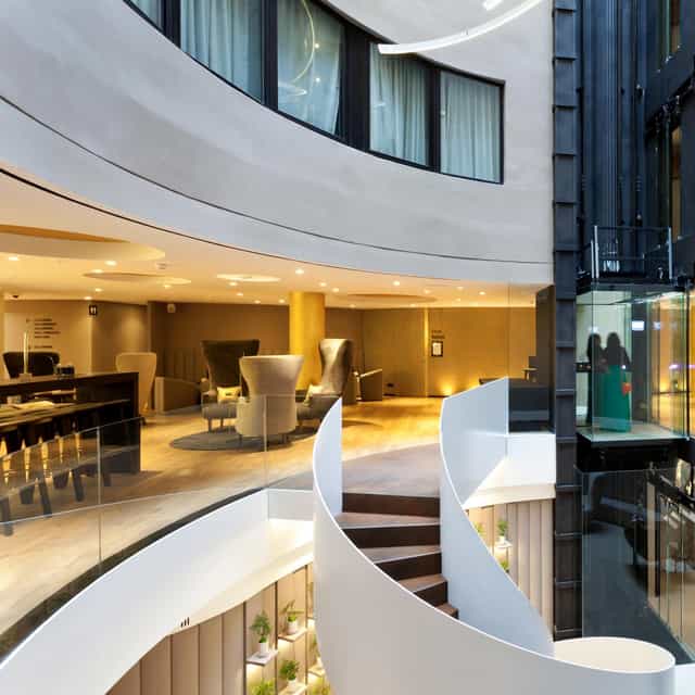 Modern hotel atrium at Burdeos, Hotel Condes de Barcelona for corporate networking and events.