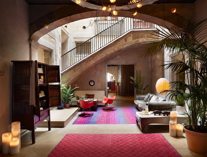 VIP hospitality breakout space at Hotel Neri with residential lounge seating for networking.