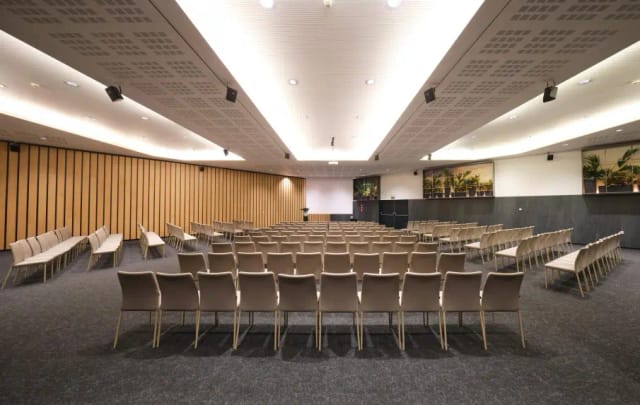 Modern auditorium at Hotel SB Icaria with curved walls for professional conferences and events.