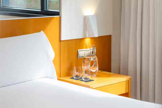 Standard guest room at Hotel SB Icaria with hydration amenities for business events and conferences.