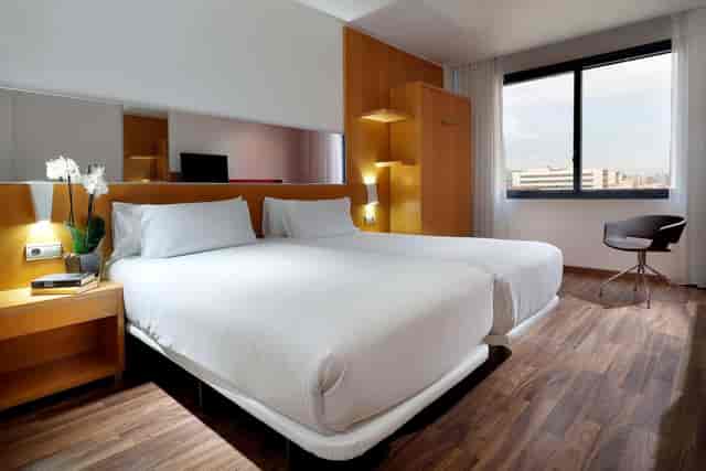 Twin-share guest room at Hotel SB Icaria with workspace for business conferences and events.