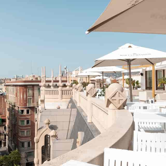 Fuster III rooftop venue: upscale networking event space with branded umbrellas and modern seating.