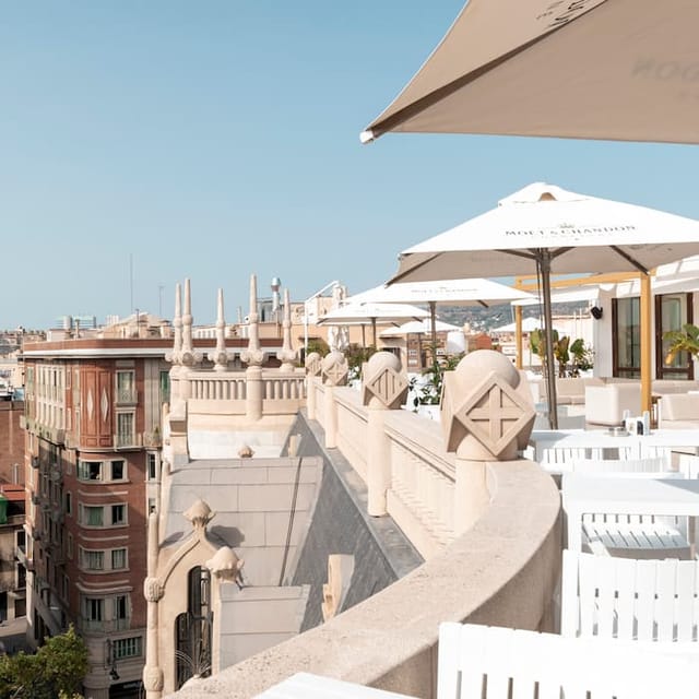 Fuster III rooftop venue: upscale networking event space with branded umbrellas and modern seating.